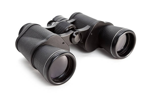 A lone pair of black binoculars on a white background stock photo
