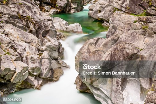 istock Long exposure of flowing water in Verzasca River at Lavertezzo - clear and turquoise water stream and rocks in Ticino - Valle Verzasca - Valley in Tessin - Travel destination in Switzerland 1330961920