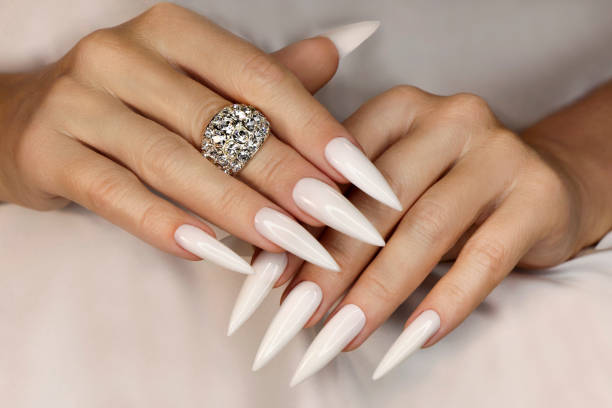 Long light manicure with ring. stock photo