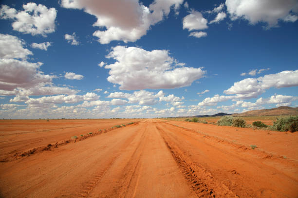 Long orange outback road under a blue sky stock photo