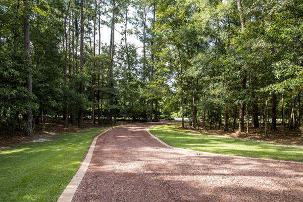 long red gravel driveway to a custom home stock photo