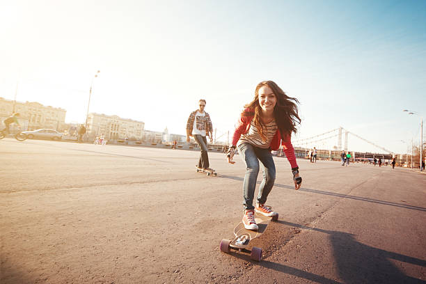 Young couple with longboards in park