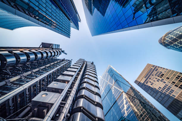 Looking directly up at the skyline of the financial district in central London - stock image Highly detailed abstract wide angle view up towards the sky in the financial district of London City and its ultra modern contemporary buildings with unique architecture. Shot on Canon EOS R full frame with 14mm wide angle lens. Image is ideal for background. financial district stock pictures, royalty-free photos & images