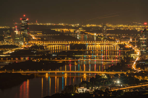Looking Down at Illuminated Bridges over Danube River in Vienna by Night stock photo