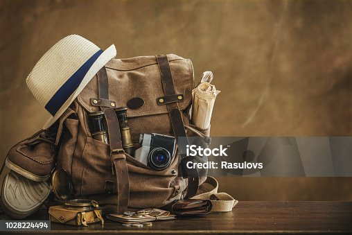 istock Looking image of travelling concept, essential vacation items. Backpack. Retro effect. 1028224494