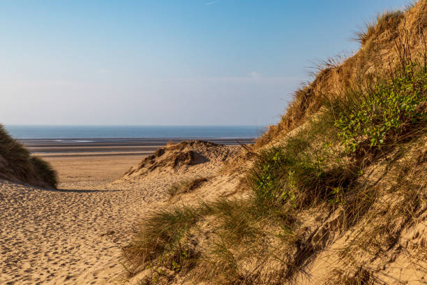 Looking out between sand dunes towards the ocean, at Formby in Merseyside stock photo