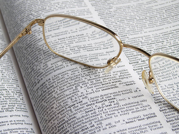 Looking through the dictionary stock photo