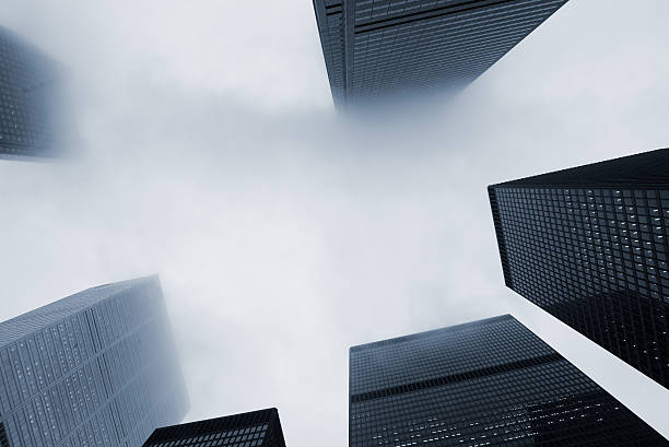 Looking Up at Skyscraper Office Buildings with Fog stock photo