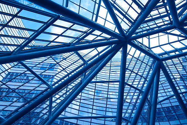 looking up into modern glass and steel business facade stock photo