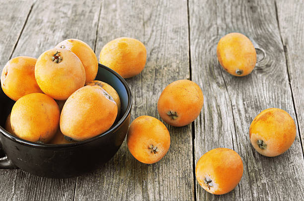 loquats on wooden background stock photo