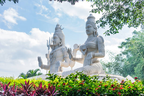 lord shiv & parvati statue at an Indian garden looking awesome with small shrubs. stock photo