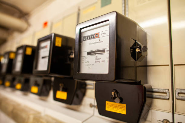 A lot of electric meter hangs in basement of a house stock photo