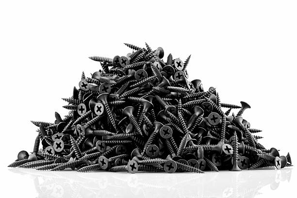 Lots of black screws isolated on white background stock photo