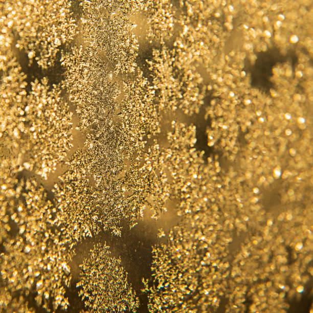Lots of golden, shiny snowflakes. Winter background. Macrophoto. Festive stock photo