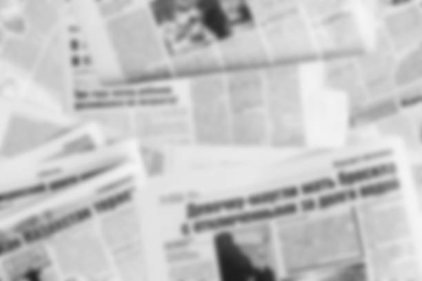 Lots of old newspapers on horizontal surface. Background texture, top view, blurred stock photo