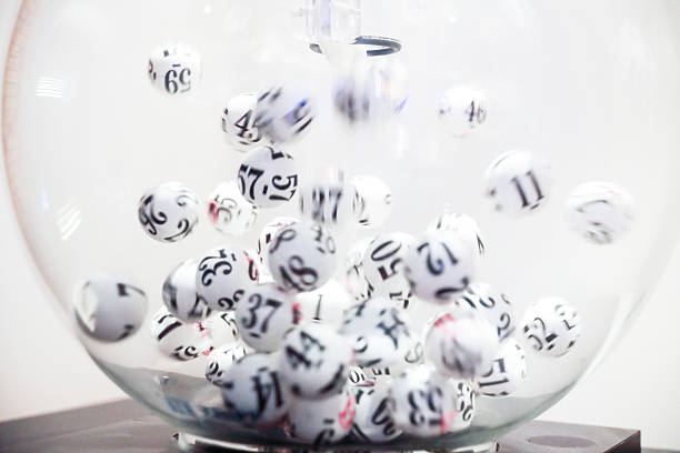 Lottery balls moving in glass sphere stock photo