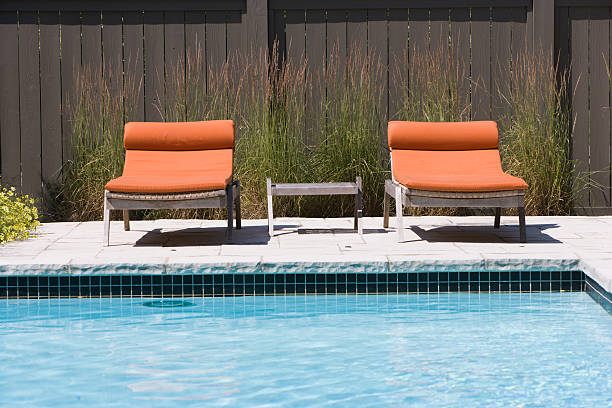 Lounge chairs by the pool stock photo
