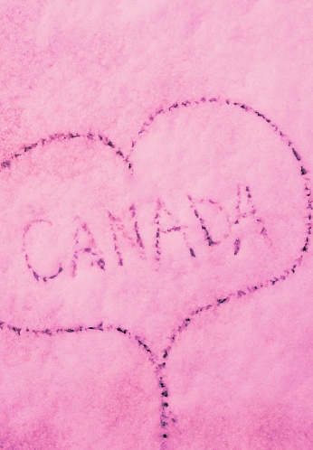 Canada written in snow with heart chape around it