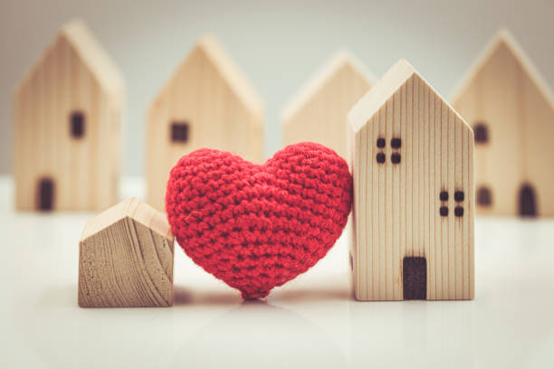 Love heart between big and small house model for stay at home love together and healthy community concept. stock photo