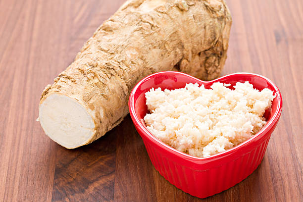 I Love Horseradish "A high angle close up of a red heart shaped bowl with freshly made horseradish in the foreground and a portion of the root from which the condiment was made. Horseradish goes good with prime rib, corned beef and other meats. Shot on a wooden background." horseradish stock pictures, royalty-free photos & images