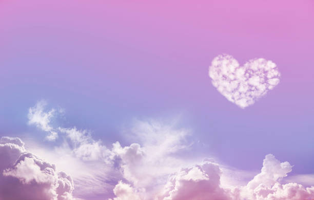 Love is in the Air Wide Blue and Pink Sky Background with fluffy clouds along the bottom and one large isolated Love Heart Shaped cloud formation above on right hand side with plenty of copy space cirrostratus stock pictures, royalty-free photos & images