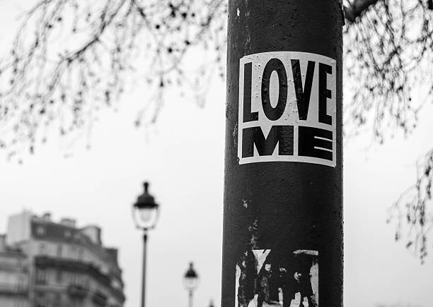 Love me sticker on streetlight. stock photo