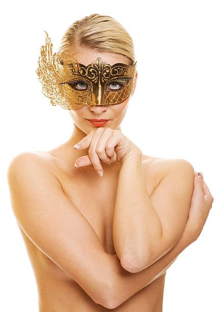 Lovely young woman with carnival mask on her face stock photo