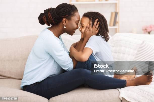 Loving black family spending time together at home