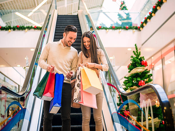 Loving couple doing Christmas shopping together stock photo