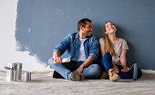 istock Loving couple having fun renovating their house and painting the walls 1339089751