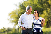 Loving happy mature couple together at walk in a park
