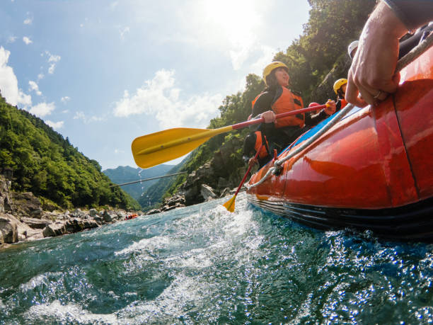 Low angle view of a white water river rafting excursion Low angle view of a white water river rafting excursion inflatable raft stock pictures, royalty-free photos & images