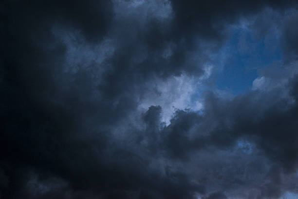 Low angle view of dark clouds on the sky stock photo