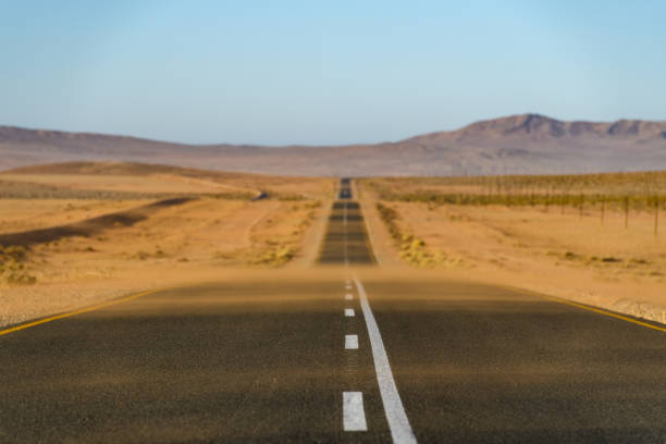 Low angle view of sand-blown road in the Namib Desert, Namibia stock photo