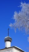 winter scene with trees and orthodox church in winter time