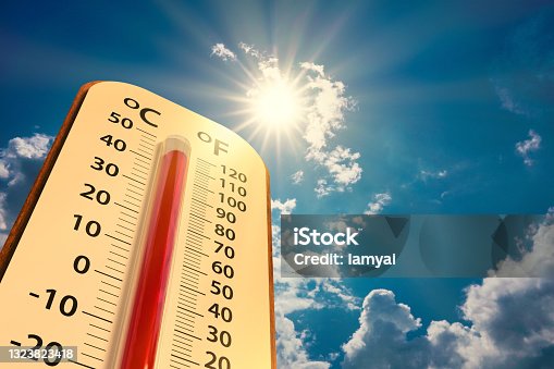 istock low angle view Thermometer on blue sky with sun shining 1323823418