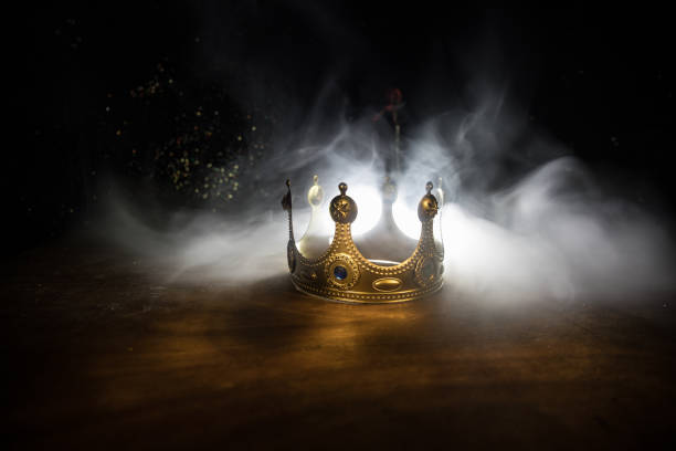 low key image of beautiful queen/king crown over wooden table. vintage filtered. fantasy medieval period stock photo