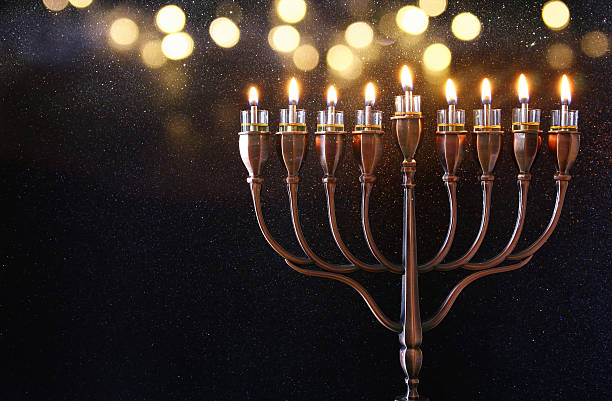 Low key Image of jewish holiday Hanukkah background Low key Image of jewish holiday Hanukkah background with menorah (traditional candelabra) and burning candles hanukkah stock pictures, royalty-free photos & images