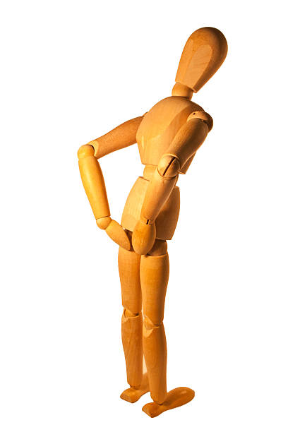 Lower Back Pain A wooden mannequin with lower back pain. cauda equina photos stock pictures, royalty-free photos & images