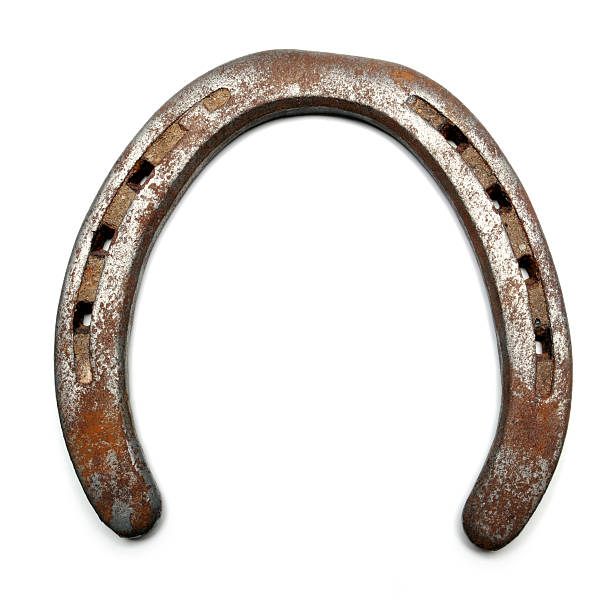 Lucky horseshoe isolated on white Closeup of a old, rusty horseshoe. horseshoe stock pictures, royalty-free photos & images