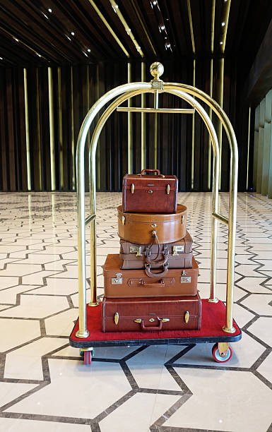 Luggage cart Luggage cart in the lobby of a luxury hotel, brown leather vintage style luggages luggage cart stock pictures, royalty-free photos & images