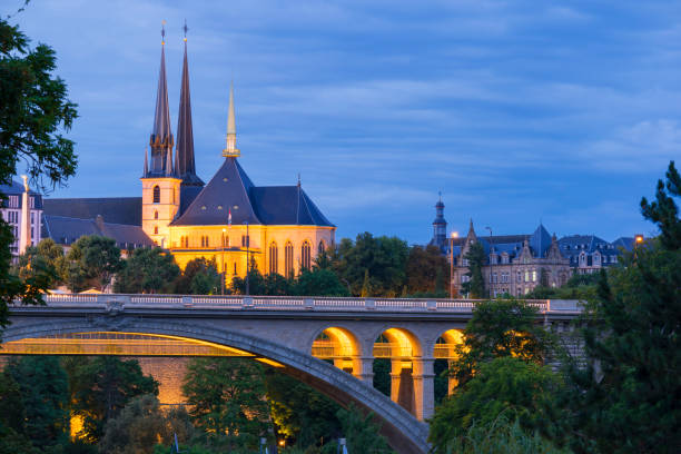 Luxembourg City Centre by Night A night view of the Notre Dame Cathedral and the Adolphe Bridge in the foreground luxembourg benelux stock pictures, royalty-free photos & images
