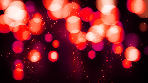 Luxury bokeh background with red glitter particles. Valentines day background with magic red light. St. valentine's day. Beautiful festive shining pattern. Party invitation card template stock photo