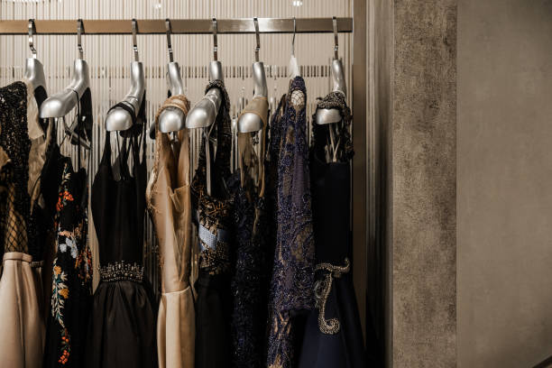 Luxury evening shining high fashion dresses Luxurious evening night out sparkling dresses hanging on the rack. High fashion concept, haute couture, designer evening gown stock pictures, royalty-free photos & images
