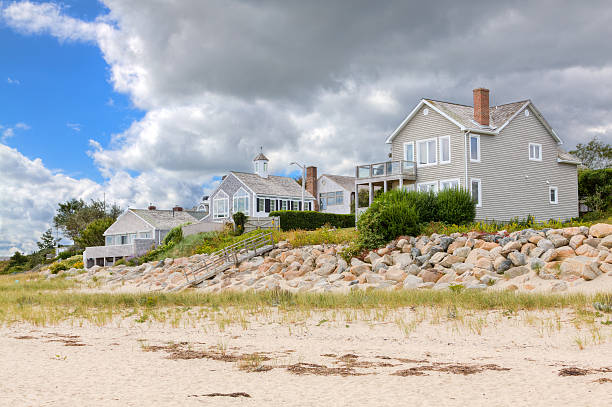 Luxury New England Waterfront Houses, Chatham, Cape Cod, Massachusetts, USA. Luxury New England Waterfront Houses on a cloudy autumn day, Chatham, Cape Cod, Massachusetts. HDR photorealistic image. cape cod stock pictures, royalty-free photos & images