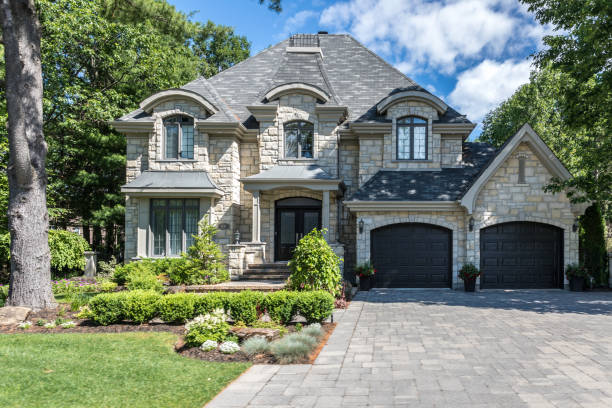Luxury Property on Sunny Day of Summer Terrebonne, Canada - June 25, 2017: Luxurious property located in Le Boisé de la pinière neighbourhood, a rich suburb of Terrebonne on a sunny day of summer. stone house stock pictures, royalty-free photos & images