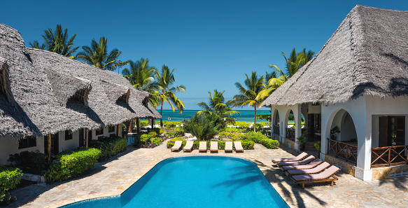 Aerial view on swimming pool in luxury holiday resort (Zanzibar, Tanzania). Property released.