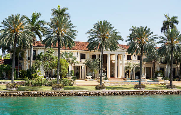 Luxury waterfront lifestyle Miami mansion viewed from water. waterfront stock pictures, royalty-free photos & images
