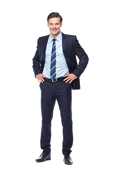 I'm the guy your company is looking for! A full length portrait of a confident young business executive with his hand on his hips hand on hip stock pictures, royalty-free photos & images