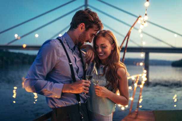I'm totally stuck on you Shot of young affectionate couple on a boat cruise flirting stock pictures, royalty-free photos & images